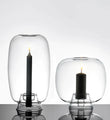 Candele nere in campane di vetro